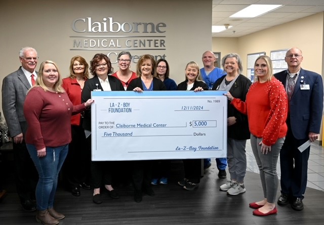 Claiborne Medical Center staff receive donation check from La-Z-Boy team