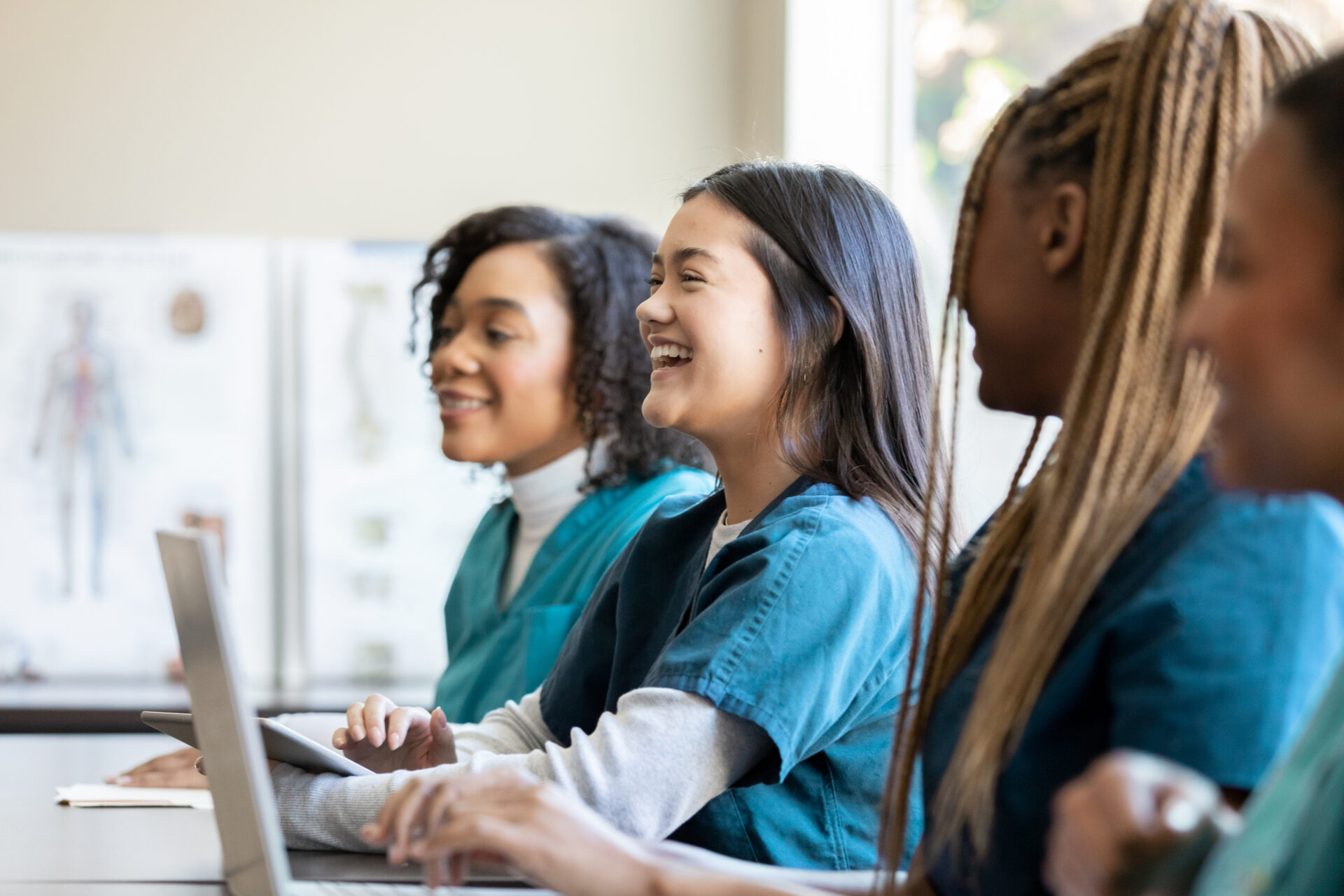 diverse group of female students in scrubs.