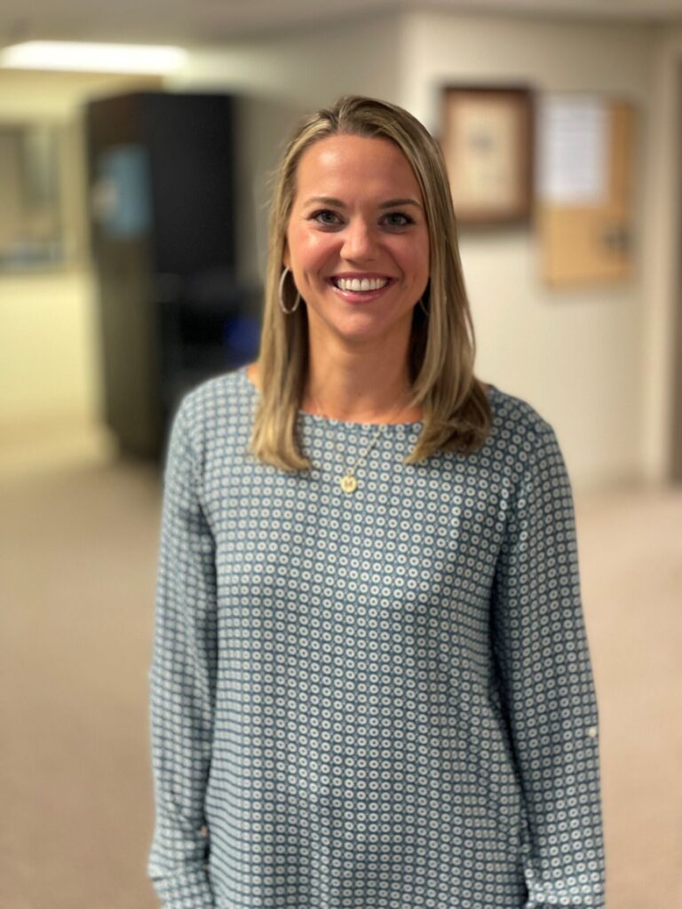 Madison Ledbetter, certified in nuerologic physical therapy, smiling in long-sleeve shirt.