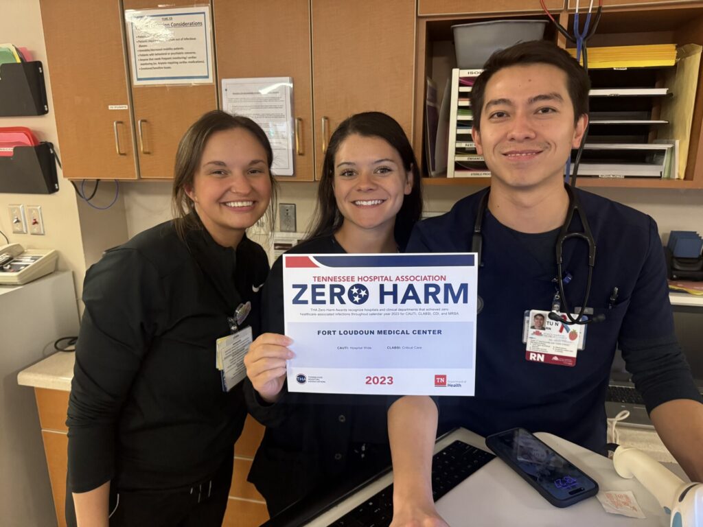 Nurses holding zero harm award sign.