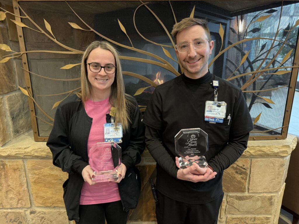 Young woman and young man who are LeConte's 2025 Silver Lamp Award Recipients stand side by side holding awards