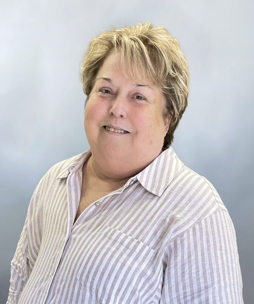 Kathy Brown headshot, woman in striped shirt